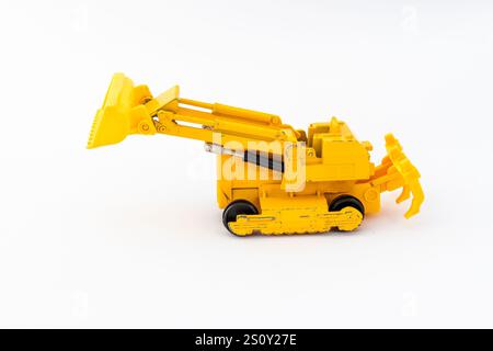 Vintage yellow miniature earth mover model on white isolated background Stock Photo