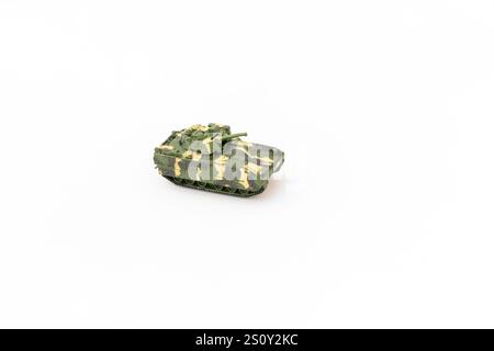 Miniature green camouflage tank on white background with copy space Stock Photo