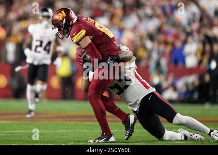 Landover, MD, USA. 29th Dec, 2024. Washington Commanders tight end Zach Ertz (86) is tackled by Atlanta Falcons linebacker Nate Landman (53) during the NFL game between the Washington Commanders and the Atlanta Falcons in Landover, MD. Reggie Hildred/CSM/Alamy Live News Stock Photo