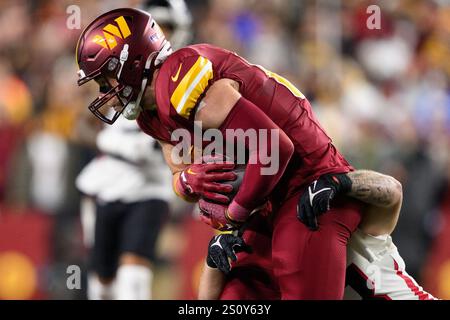 Landover, MD, USA. 29th Dec, 2024. Washington Commanders tight end Zach Ertz (86) is tackled by Atlanta Falcons linebacker Nate Landman (53) during the NFL game between the Washington Commanders and the Atlanta Falcons in Landover, MD. Reggie Hildred/CSM/Alamy Live News Stock Photo