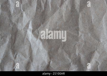 Crumpled paper texture. Wrinkled recycled brown wrapping paper background. Grunge backdrop. Stock Photo