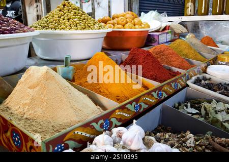 ground spices dry herbs olives and fresh food on display in a stall in the jewish food market marrakesh, morocco Stock Photo