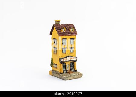 Miniature yellow bookshop model isolated on white background Stock Photo
