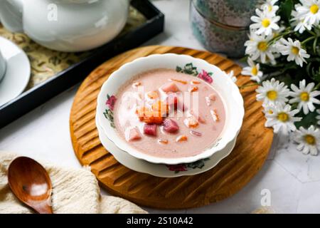 Bubur Cha Cha is a creamy coconut dessert with colorful cubes of purple, orange, and white sweet potatoes and yam. Stock Photo