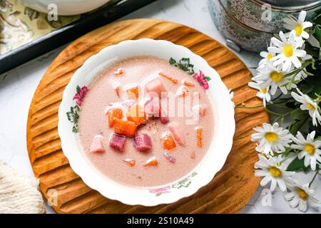 Bubur Cha Cha is a creamy coconut dessert with colorful cubes of purple, orange, and white sweet potatoes and yam. Stock Photo