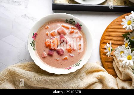 Bubur Cha Cha is a creamy coconut dessert with colorful cubes of purple, orange, and white sweet potatoes and yam. Stock Photo