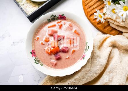 Bubur Cha Cha is a creamy coconut dessert with colorful cubes of purple, orange, and white sweet potatoes and yam. Stock Photo