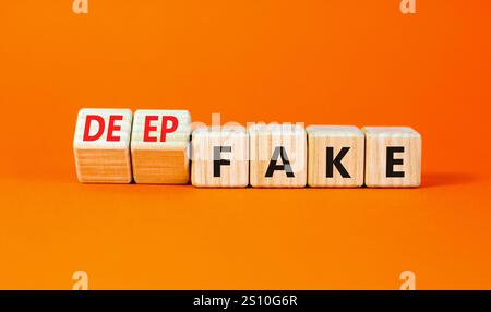 Deepfake or fake symbol. Concept words Fake Deepfake on wooden cubes. Beautiful orange table orange background. Business and deepfake or fake concept. Stock Photo