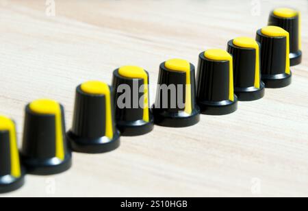 Lots of volume controls on the table. Radio components for repairing electronic equipment. Home workshop. Stock Photo