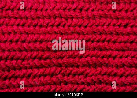 Crochet texture. Red wool blend yarn, close-up pattern sample. Stock Photo