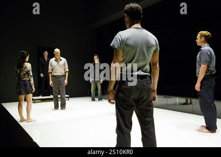 left: Phoebe Fox (Catherine)  left centre: Mark Strong (Eddie Carbone) in A VIEW FROM THE BRIDGE by Arthur Miller at the Young Vic, London SE1  11/04/2014  set & lighting design: Jan Versweyveld  costumes: An D'Huys  director: Ivo Van Hove Stock Photo