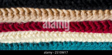 Texture of wool blend yarn samples. Close-up of multi-colored crochet patterns. Stock Photo