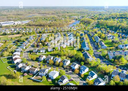 Aerial view captures suburban neighborhood filled with houses, streets, green spaces at American small town New Jersey Stock Photo