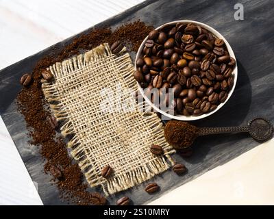 Coffee cone with ground coffee lie on coffee beans on burlap. Menu of coffee drinks. Stock Photo