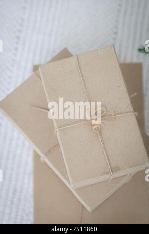 Three brown boxes stacked on top of each other. The boxes are tied together with a string Stock Photo
