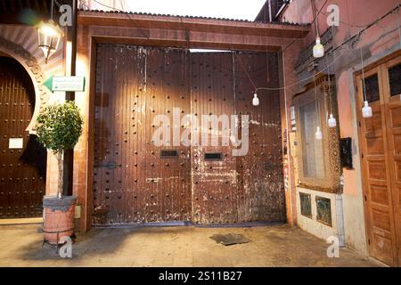 old wooden gates closed across the entrance to souk el bahja in early morning marrakesh, morocco Stock Photo