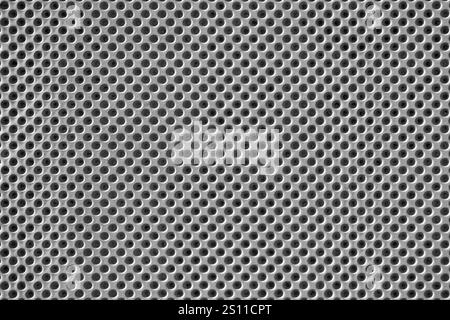 Gray concrete with hole pattern - close-up of a wall cladding Stock Photo
