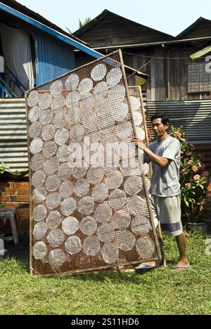 Rice paper for spring rolls dries in the sun on bamboo racks in the ...