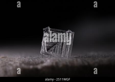 White crystal on black background, minimalistic photo, place for inscription, dark copy space, salt crystals Stock Photo