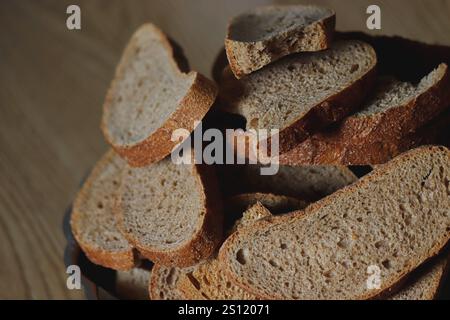 Slices of black bread are cut on a cutting board. Stock Photo