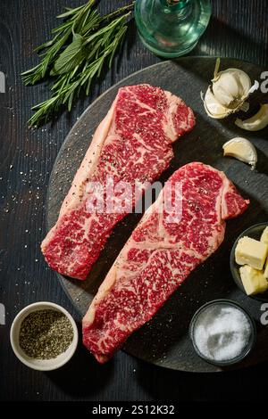 fresh raw Australian Wagyu steak on black wooden kitchen table surface, top view Stock Photo