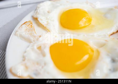 A closeup view of two sunny side up eggs. Stock Photo