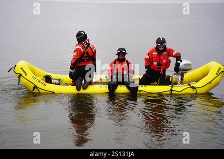 A crew assigned to Coast Guard Station Manistee transits on a skiff ice Jan. 30, 2024, on Manistee Lake, Manistee, MI. The crew conducted ice helo ops with Coast Guard Air Station Traverse City to enhance their rescue training techniques during the winter season. (U.S. Coast Guard photo by Seaman Christine Bills) Stock Photo