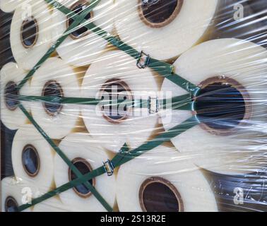 Fragment of a pallet with large rolls of protective film Stock Photo