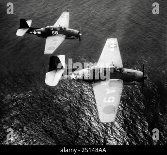 Grumman TBF Avengers from USS Santee in flight. An American World War II-era torpedo bomber developed initially for the United States Navy and Marine Corps, but eventually used by several air and naval aviation services around the world. It entered U.S. service in 1942, and first saw action during the Battle of Midway. Despite the loss of five of the six Avengers on its combat debut, it survived in service to become the most widely-used torpedo bomber of World War II. Stock Photo