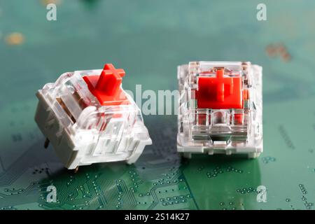 Keys for a mechanical keyboard on a green printed circuit board. Stock Photo