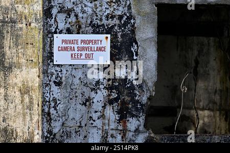 Harbour, Brixham, Devon, UK. 25th Dec 2024. A sign reads "PRIVATE PROPERTY CAMERA SURVEILLANCE KEEP OUT" on an old concrete building on the Breakwater. Stock Photo