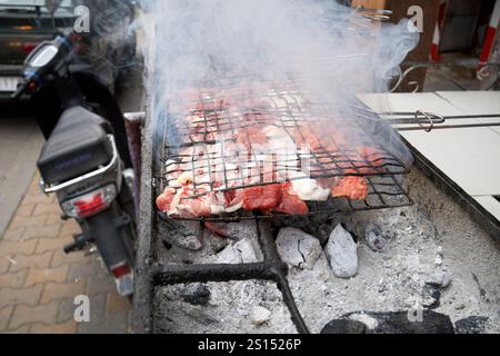 cooking meat by the roadside in a cafe over hot charcoal open air cooking imlil morocco Stock Photo