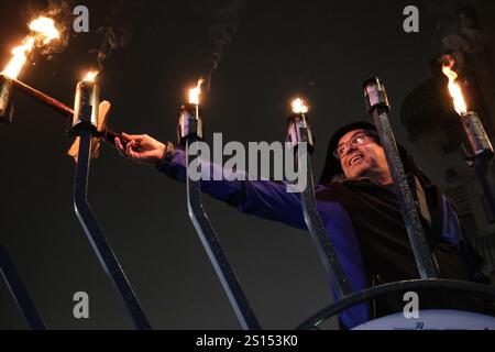 Jerusalem, Israel. 31st Dec, 2024. A Jewish man lights seven candles on