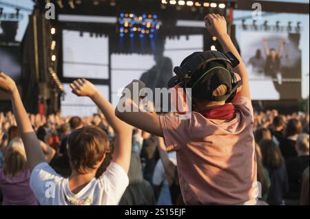 Applause of a boy with headphones during music concert Stock Photo