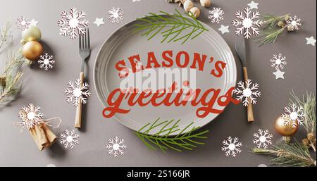 Image of christmas greetings text over christmas place setting and decorations Stock Photo