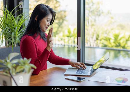 Businesswoman having video call on laptop in office online meeting tax accounting financial concepts, Woman doing meeting and accounting analysis, Rep Stock Photo