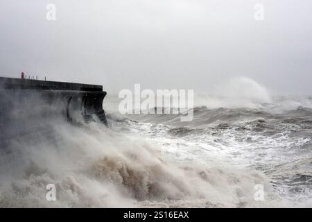 Waves crashing in Dover, Kent, as wind, rain and snow warnings are in force across parts of the UK, with the threat of flooding and disruption to New Year's Day travel. Large parts of England and Wales will be hit by strong winds until 3pm on Wednesday, while north-west England and Wales are forecast to see heavy rain for much of the morning.. Picture date: Wednesday January 1, 2025. Stock Photo