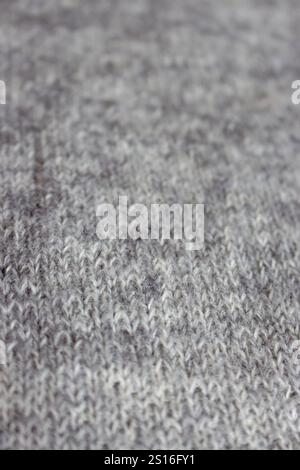 Grey melange knitting background. Mix of grey wool and white cashmere. Knitting pattern background. Knit stitch pattern. Knitting lifestyle. Stock Photo