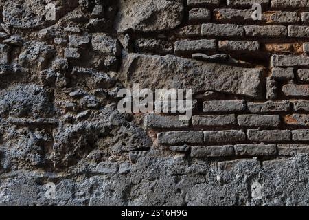 Close-up of a weathered stone and brick wall texture, showcasing intricate details of historic Sicilian architecture. Perfect for backgrounds, 3D rend Stock Photo