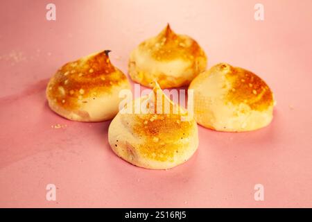 Scone donuts with strawberry jelly and meringue and vanilla custard on a pink background. Stock Photo