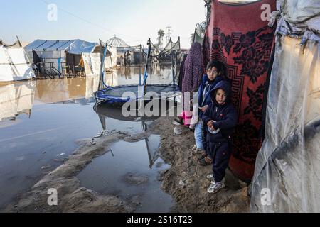 Palestinian children stand on an area surrounded by makeshift tents in ...