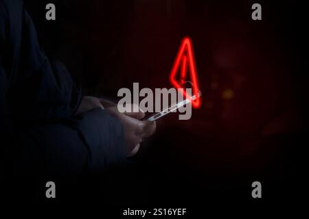 Lady with warning notification and spam message icon on mobile phone Stock Photo