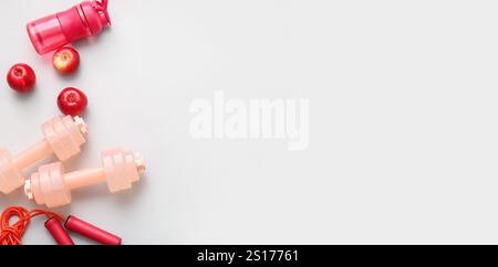 Sports equipment and apples on light background with space for text Stock Photo