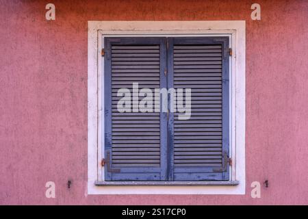 Blue window shutter and pink wall Stock Photo