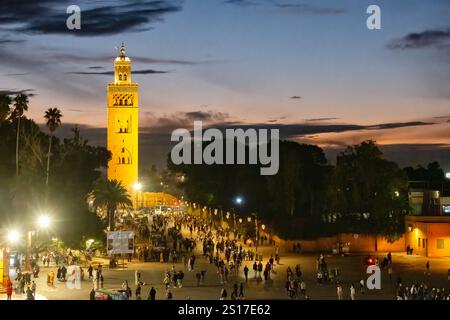 Marrakesh Morocco. A view of the Kutubiyya Mosque located in the Marrakech medina.The view is in the early evening from a busy Jemaa el-Fnaa Stock Photo