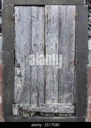Window boarded up in an abandoned house. Stock Photo