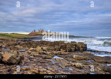Dunstanburgh Castle from the southern beach in the winter, Northumberland AONB, England Stock Photo
