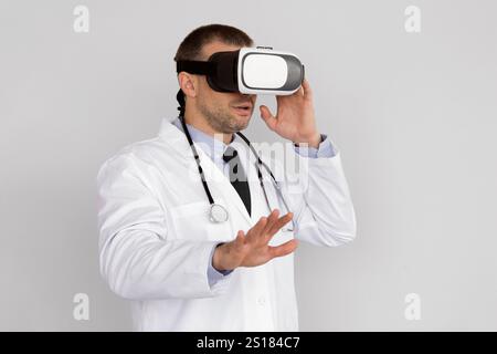Male Doctor Using Virtual Reality Headset For Medical Purposes Stock Photo