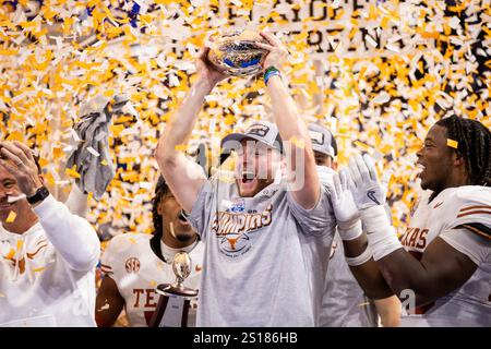 Atlanta, GA, USA. 1st Jan, 2025. Texas quarterback Quinn Ewers (3) raises the Peach Bowl trophy after winning the CFP Quarterfinal at Mercedes-Benz Stadium in Atlanta, GA. (Scott Kinser/CSM). Credit: csm/Alamy Live News Stock Photo