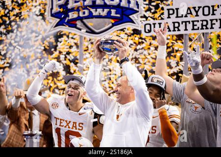 Atlanta, GA, USA. 1st Jan, 2025. Texas head coach Steve Sarkisian raises the Peach Bowl trophy after winning the CFP Quarterfinal at Mercedes-Benz Stadium in Atlanta, GA. (Scott Kinser/CSM). Credit: csm/Alamy Live News Stock Photo